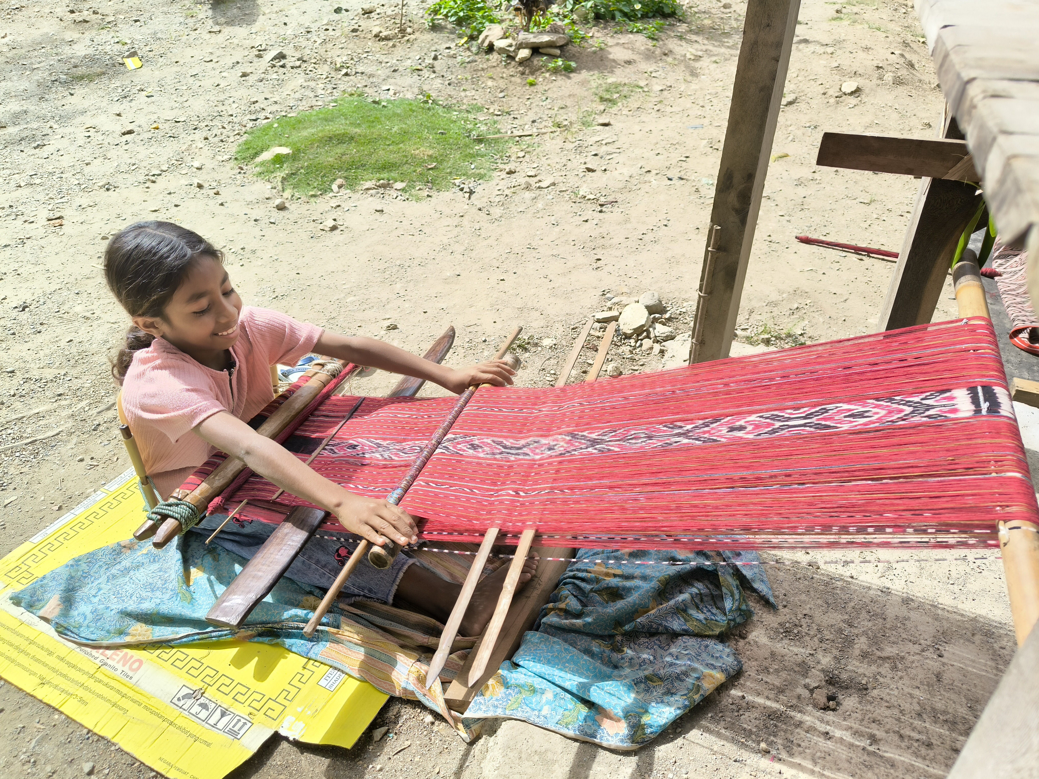 Salah seorang anak perempuan belajar menenun di Sekolah Tenun Kampung Desa Tokbesi, TTU, NTT. (Foto: Fitria Werdiningsih-WFL)